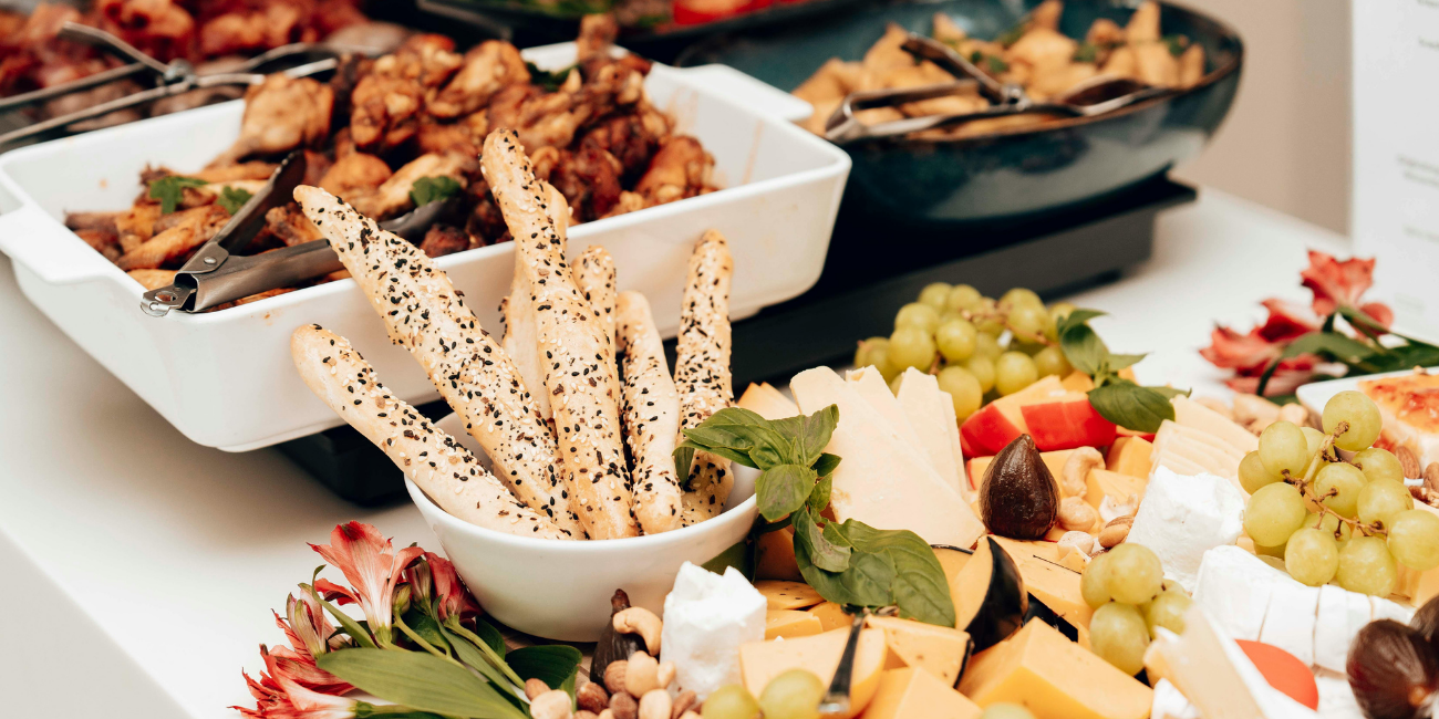 A colorful buffet spread showcasing an assortment of foods and pastries for guests to enjoy.