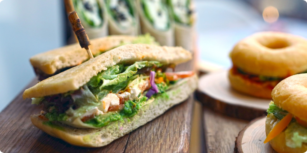 A table displaying an assortment of sandwiches and donuts, inviting for a casual dining experience
