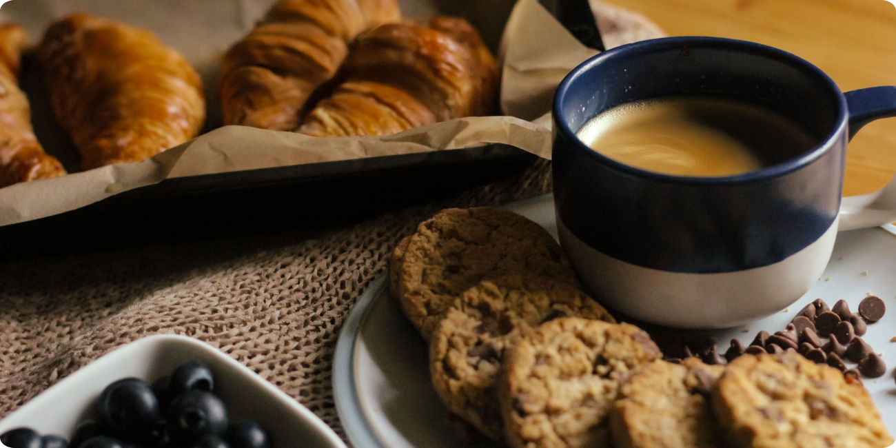 A table set with coffee and croissants, showcasing a delightful multi-cuisine breakfast spread